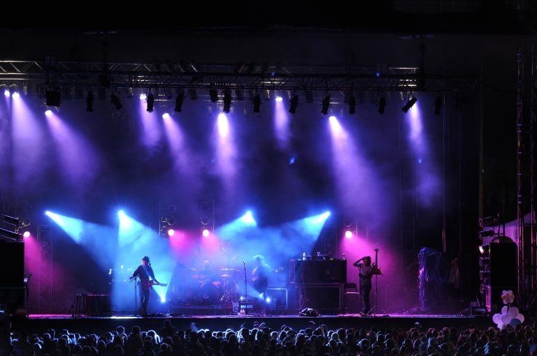 Rock concert on stage outside silhouette of singers on stage