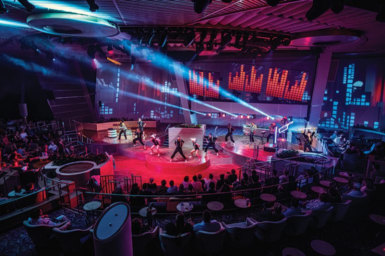 OV, Ovation of the Seas, Two70 show, roboscreens, Pixels, entertainment, night, wide shot of performers on stage, singing, singers, actors, dancers, musicians playing, audience in round, spotlights