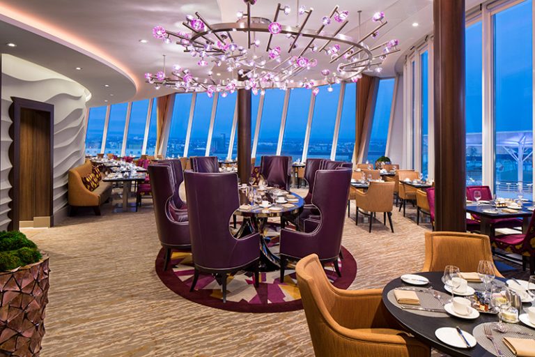 SY, Symphony of the Seas, Coastal Kitchen restaurant - Deck 17 Midship Portside, table seating, shoreside view window at night, evening, dusk, decor, decorative lighting