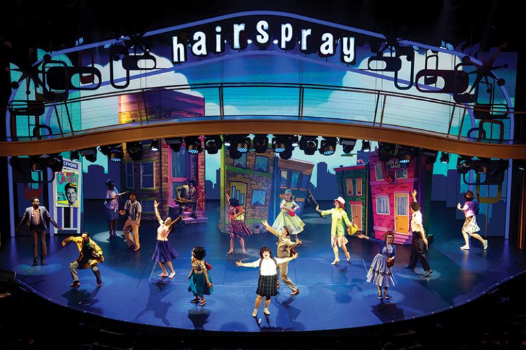 SY, Symphony of the Seas, Hairspray, Entertainment Place, performance, performers, Broadway, Play, Actress, Actor, Theater, Dancing, singing cast, singers, scenery, Hairspray signage lit up above stage, wide view of stage,