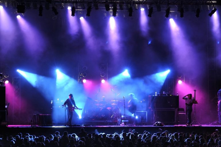 Rock concert on stage outside silhouette of singers on stage