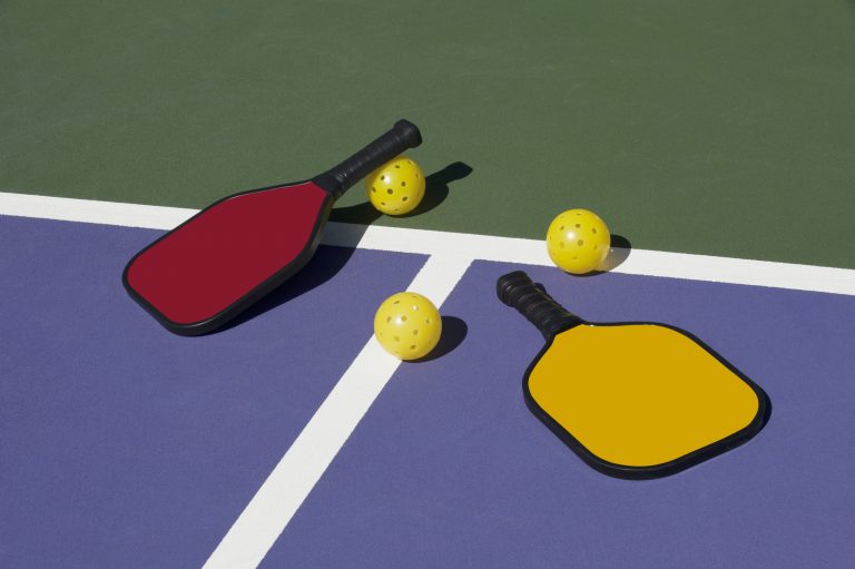 Pickleball Paddles and Ball(s) On Court