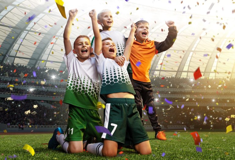 winning football player Children after score in a match confetti and tinsel