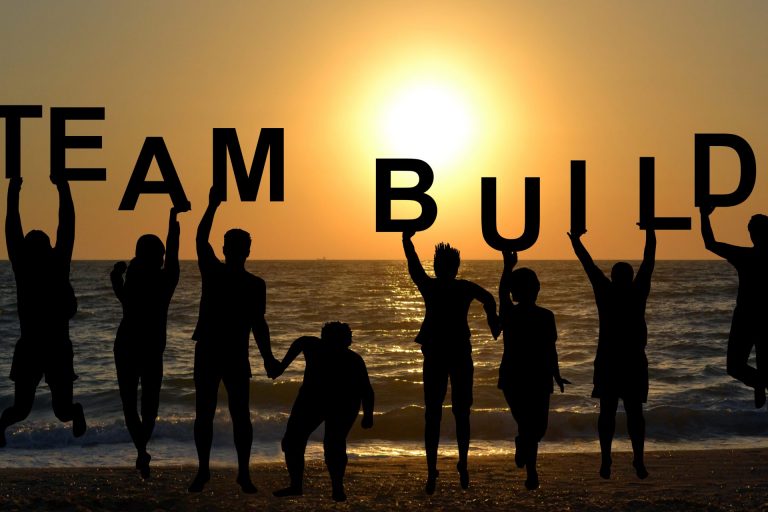 Team building concept with people entertaining on beach