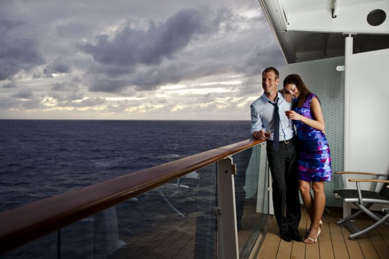 Couple enjoying cocktails on the (veranda, balcony), Couple watching the sunset from their stateroom (veranda, balcony), Onboard Celebrity Solstice relaxation, SL Class